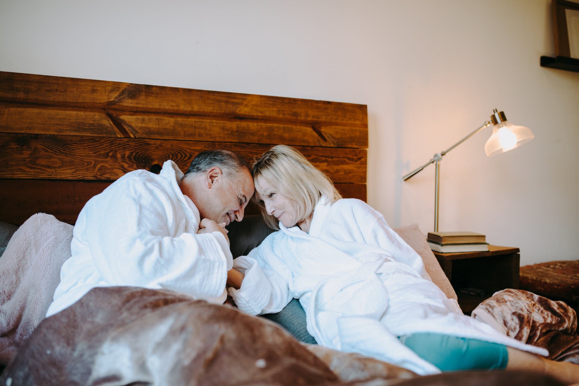 Two people holding eachother in bed