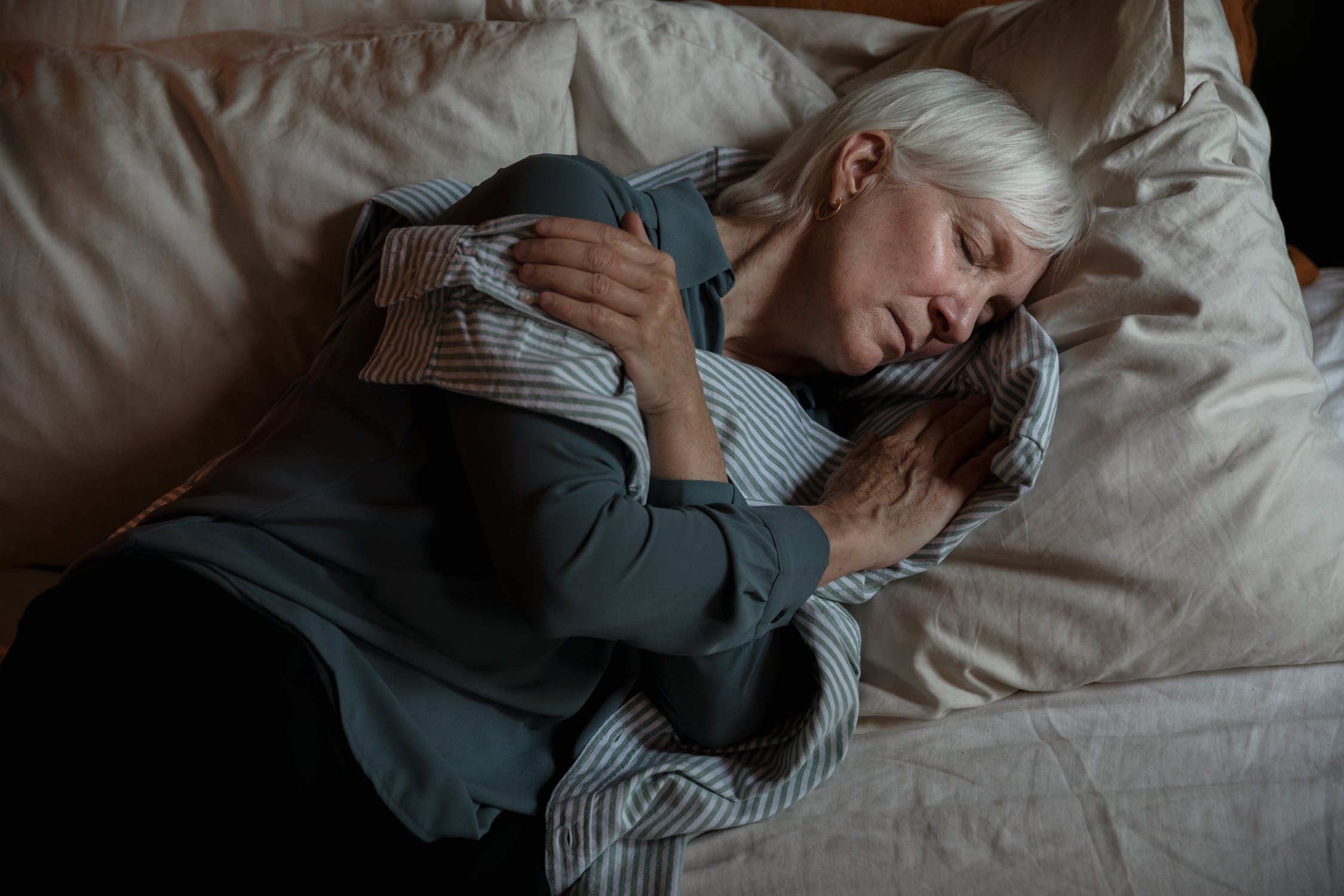 Two people holding eachother in bed